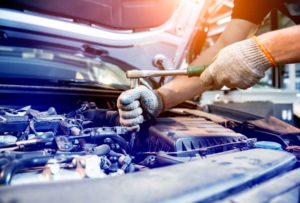 Car mechanic repair engine at service station. Car repair