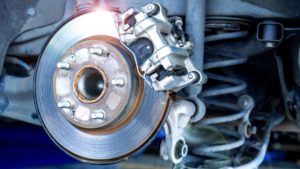 Car parts and disk brake concept - Closeup car disk brake maintenance service in car garage and copy spcae